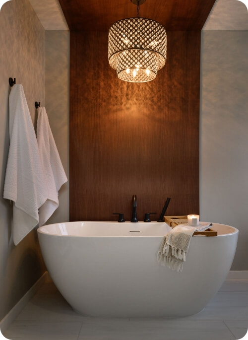 Elegant modern bathtub with stylish lighting and towels
